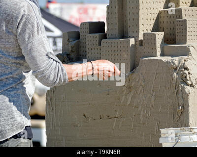 Laura Cimador-Gowdy's hand at work on the 1st place wining sand sculpture, 'Opposites Attract,'  Master Duo category. Texas Sandfest 2019, Stock Photo