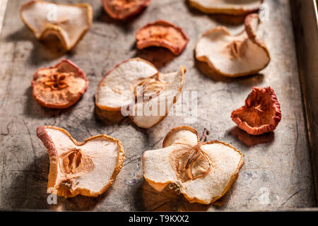 Closeup of tasty dried apples on old baking tray Stock Photo