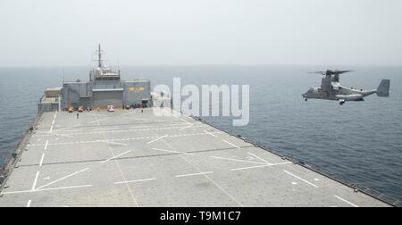 A U.S. Marine Corps MV-22B Osprey aircraft approaches to land aboard the expeditionary sea base USS Lewis B. Puller May 11, 2019 in the Arabian Sea. The Puller is the first Expeditionary Mobile Base designed for forward deploy aviation, ground, and logistics forces for conflicts. Stock Photo