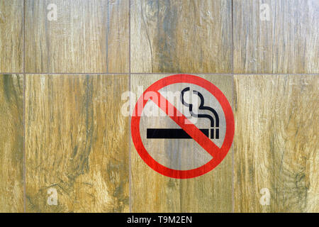 On the wall is a Smoking ban sign in the toilet Stock Photo