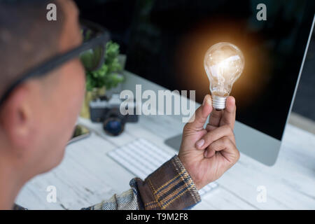 A hand holding is light bulb, Creative ideas concept, lightbulb for new idea, object design for thinking - Image - Image Stock Photo