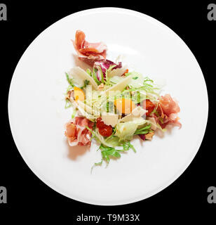 Salad with prosciutto ham, ripened cheese, dried cherry tomatos and lettuce Stock Photo