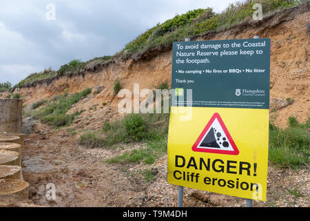 Danger Cliff Erosion Sign warning of hazardous rock falls at Lepe Beach, Hampshire, UK Stock Photo