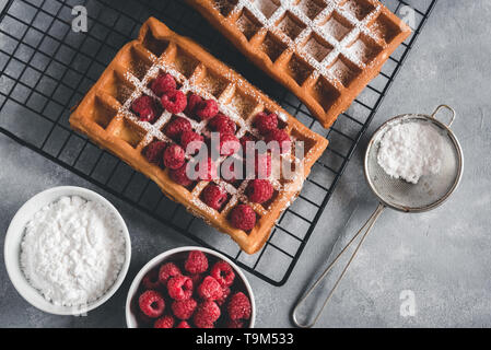 Homemade waffles with raspberries on grey table Stock Photo