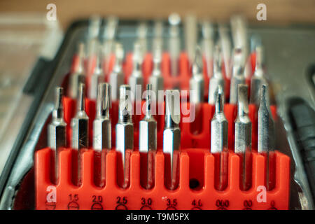 Bit set with different screws Bits in a red plug box Toolbox Stock Photo