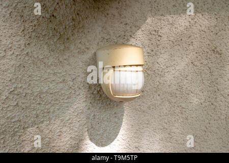 Motion detector on a house wall for quick light adjustment Stock Photo