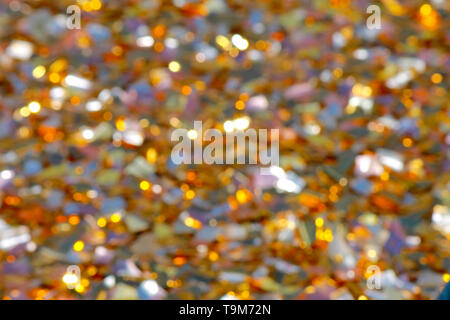Bright blurred background of pieces of color chopped foil glistening in the sun. Festive, wedding, birthday background Stock Photo