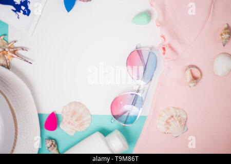 Summer vacation composition. Beach accessories on white light blue background. Vacation and travel items. Frame, flat lay, soft focus. Stock Photo