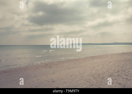 sea ​​landscape in the rays of the sun coming out from behind the clouds Stock Photo