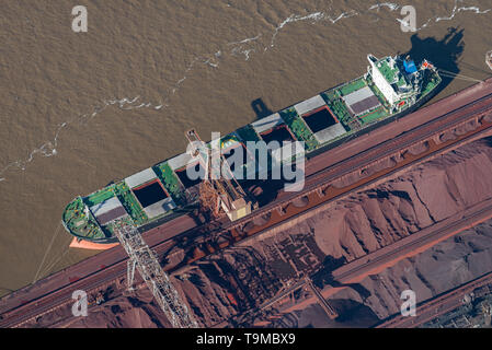 aerial image of cargo vessels loading on the Parana River at Muelle Carbon Siderar in the port of Barrio 7 de Septiembre, San NicolÃ¡s de los Arroyos, Stock Photo