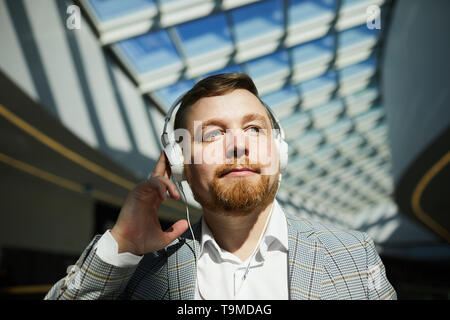 Inspired man listening to music in headphones Stock Photo