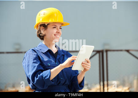 Smiling Female Worker Outdoors Stock Photo