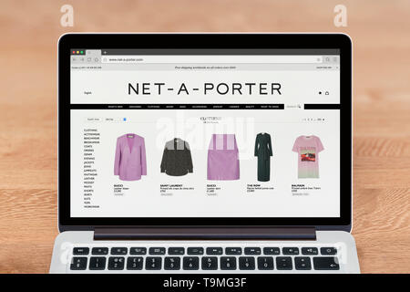 An Apple Macbook displays the Net-a-Porter website (Editorial use only). Stock Photo