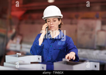 Female Worker Speaking by Phone Stock Photo