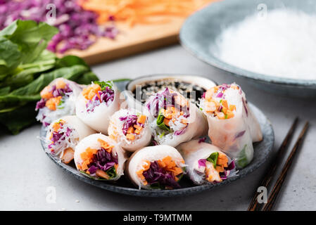 Vietnamese rice paper rolls with shrimp, red cabbage, carrot and rice noodles. Asian cuisine food. Spring rolls Stock Photo