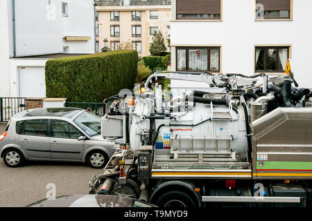 Paris, France - Apr 24, 2019: Detail mechanism of New Capellotto Sewage truck on city street in working process to clean up sewerage overflows, cleaning pipelines and potential pollution issues Stock Photo