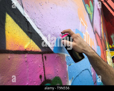 Hand Holding a Spray Can, Graffiti Artist at the Wall Stock Photo - Alamy