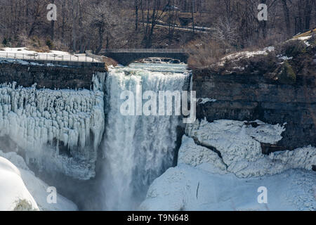 Winter scene of Niagara Falls in Canada showing frozen snow covered boulders and white snow Stock Photo