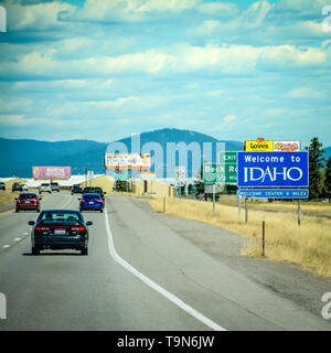 Big blue 'Welcome to Idaho' roadway sign off of Interstate 90 heading East from Washington State, USA Stock Photo