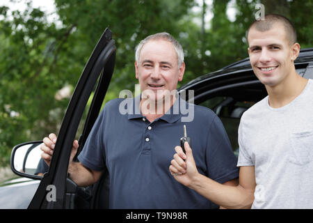 happy young man holding car keys Stock Photo