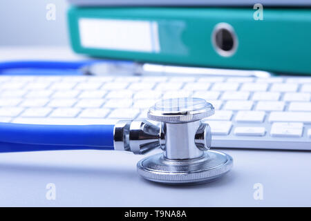 books folder file, stethoscope and laptop, keyboard isolated on white background. Stock Photo