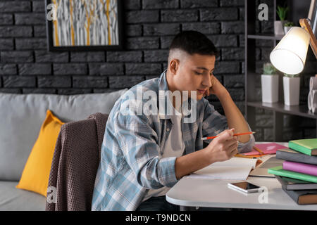 Male student preparing for exam at home Stock Photo
