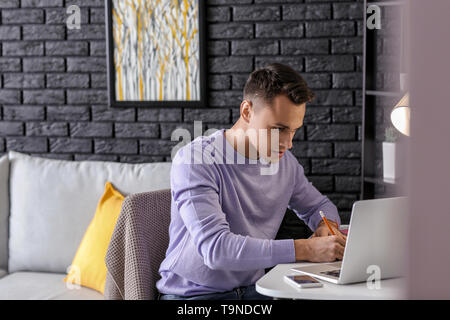 Male student preparing for exam at home Stock Photo
