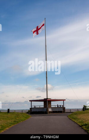 Lytham, Lancashire, United Kingdom. 19th May, 2019. Patriotic English Saint Georges Cross being flown over the Promenade Shelter on the front at Lytham. Credit: Photographing North/Alamy Live News Stock Photo