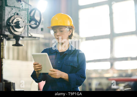 Worker Using Tablet at Factory Stock Photo