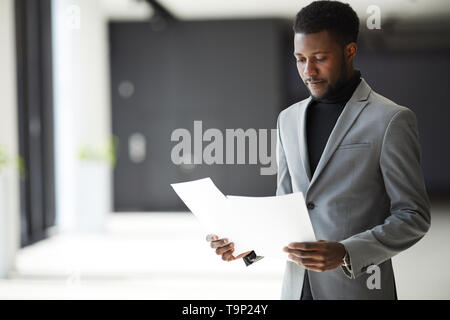 African-American manager examining documents Stock Photo