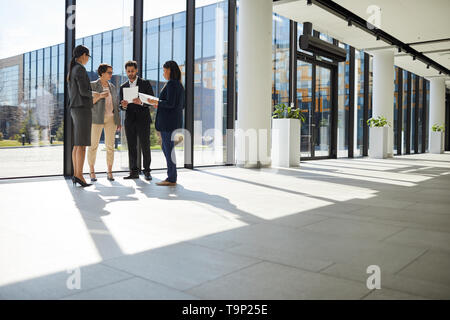 Business people analyzing paper data Stock Photo