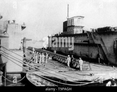 Royal Navy HMS Implacable in Port Said, Egypt, alongside captured German dry dock Nov 1915 Stock Photo