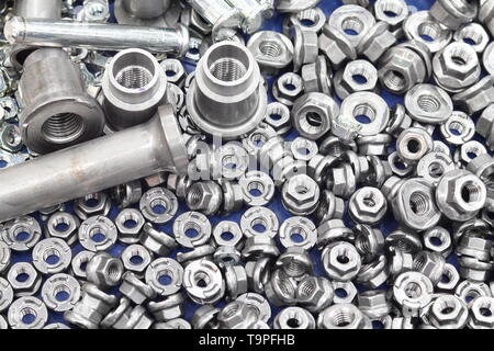 small bolts and nuts by manufacturing process ; tapping Stock Photo