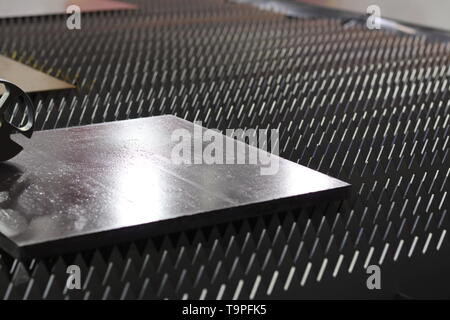 a steel plate on machine , ready for processing ; close up Stock Photo