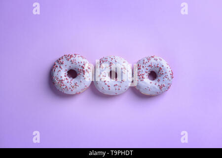 Tasty doughnuts on color background Stock Photo