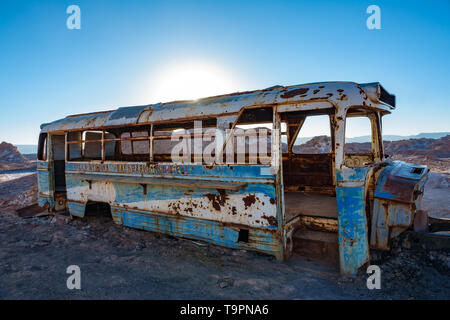 Abandoned bus backlit in the desert of Atacama, Chile Stock Photo