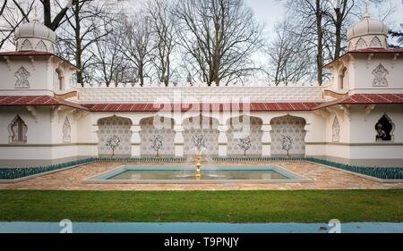 Traditional Persian design of the persian palace with painted walls, tiles and wooden doors, attraction in themepark with fakir on a flying carpet. Du Stock Photo