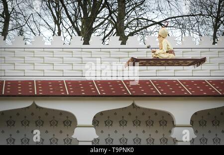 Traditional Persian design of the persian palace with painted walls, tiles and wooden doors, attraction in themepark with fakir on a flying carpet. Du Stock Photo