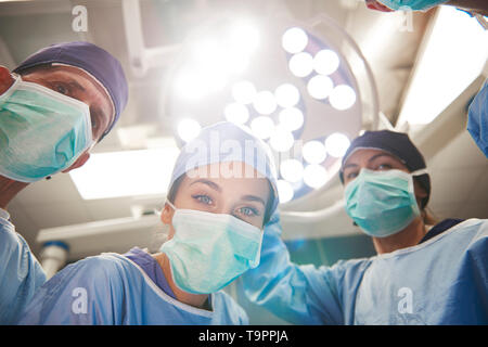 Low angle view of surgeons over the operating table Stock Photo