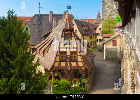 Great view of the old forge (Gerlachschmiede) with its graceful gable, pretty windows and vibrant coat of arms in Rothenburg ob der Tauber next to the... Stock Photo
