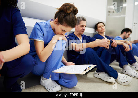 Female doctor examining the medical record Stock Photo