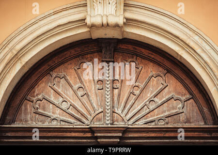 KRAKOW,POLAND-23 APRIL,2019: Old Polish house exterior.Wooden arch over fron door in ancient building in Krakow town.Beautiful vintage architecture details in close up Stock Photo