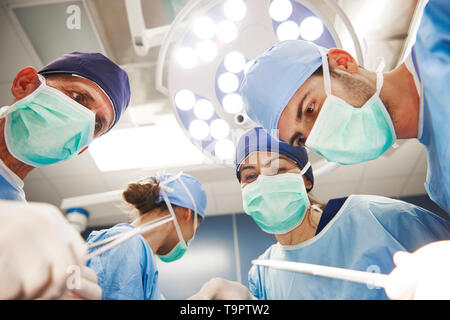 Low angle view of surgeons over the operating table Stock Photo