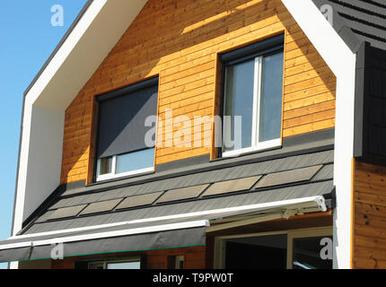 Close up on House Blinds Sun Protection Exterior.  Windows in New Modern Passive House Facade Wooden Wall with Shutters Closed and Opened Outdoors. Stock Photo