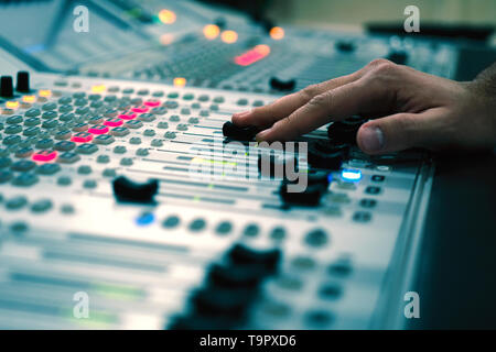 Professional audio mixing console with faders and adjusting knobs - radio / TV broadcasting Stock Photo