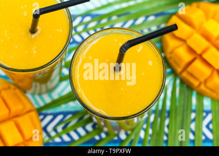 Fresh tropical fruit smoothie mango juice and fresh mango. Close up. Stock Photo