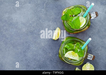 https://l450v.alamy.com/450v/t9pxgg/mojito-cocktail-in-glass-jars-on-grey-stone-background-copy-space-top-view-t9pxgg.jpg