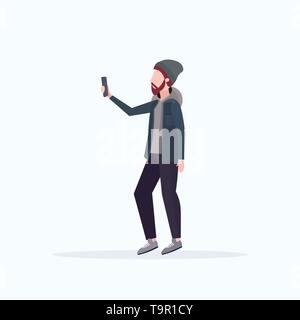 man taking selfie photo on smartphone camera casual male cartoon character in hat posing on white background flat full length Stock Vector