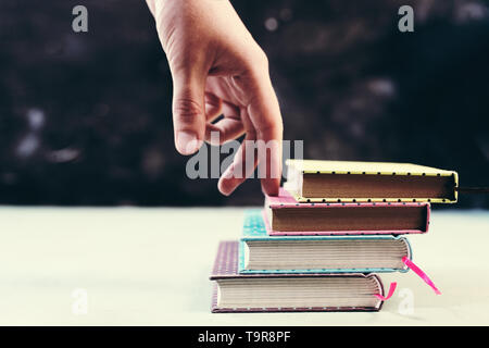 Success concept with fingers climbing stairs made of books stack Stock Photo