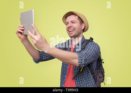 man tourist in summer hat using digital tablet Stock Photo